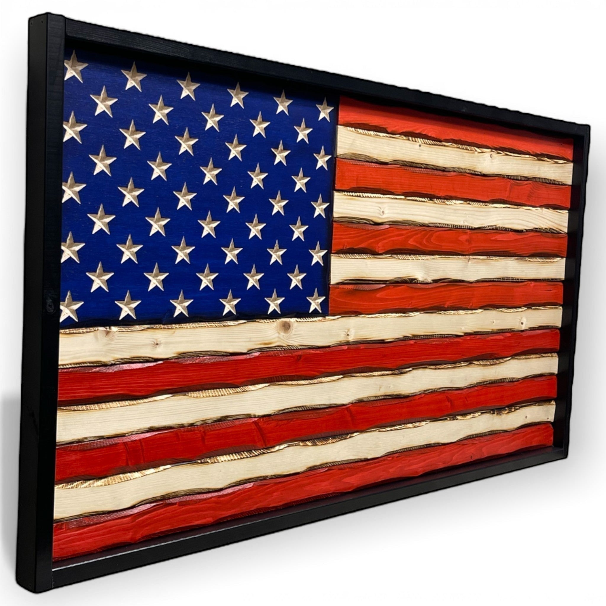 Breacher Rustics wooden American flag with carved stars, red and white stripes, and a battle-worn patina finish in a black frame. rustic battle worn american flag wood wall decor carved patriotic home decoration wooden flag usa made