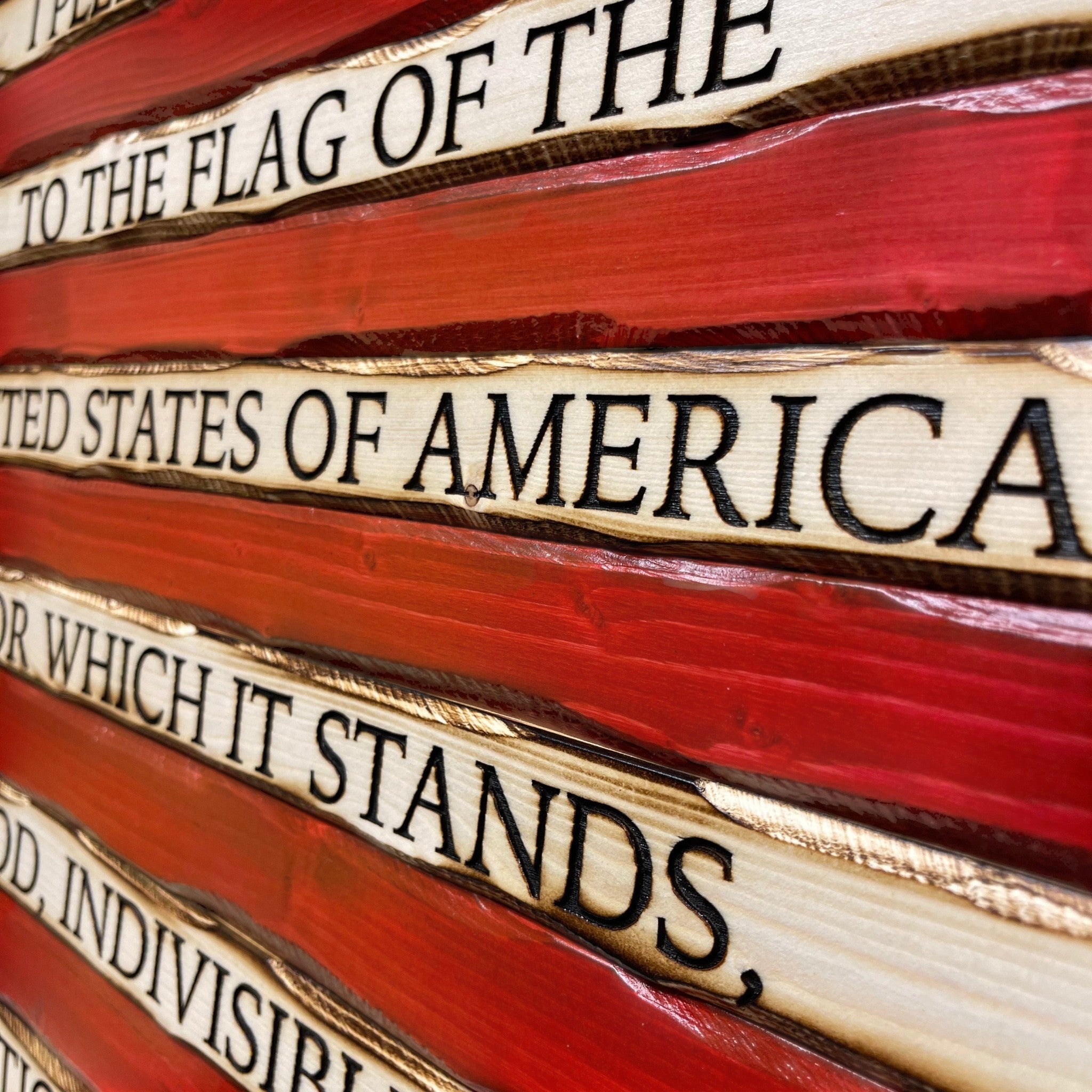 Breacher Rustics battle worn carved wood American flag with Pledge of Allegiance text and carved stars. Red and natural wood finish. american flag with pledge carved wood patriotic wall decor handmade rustic wooden flag usa made craftsmanship