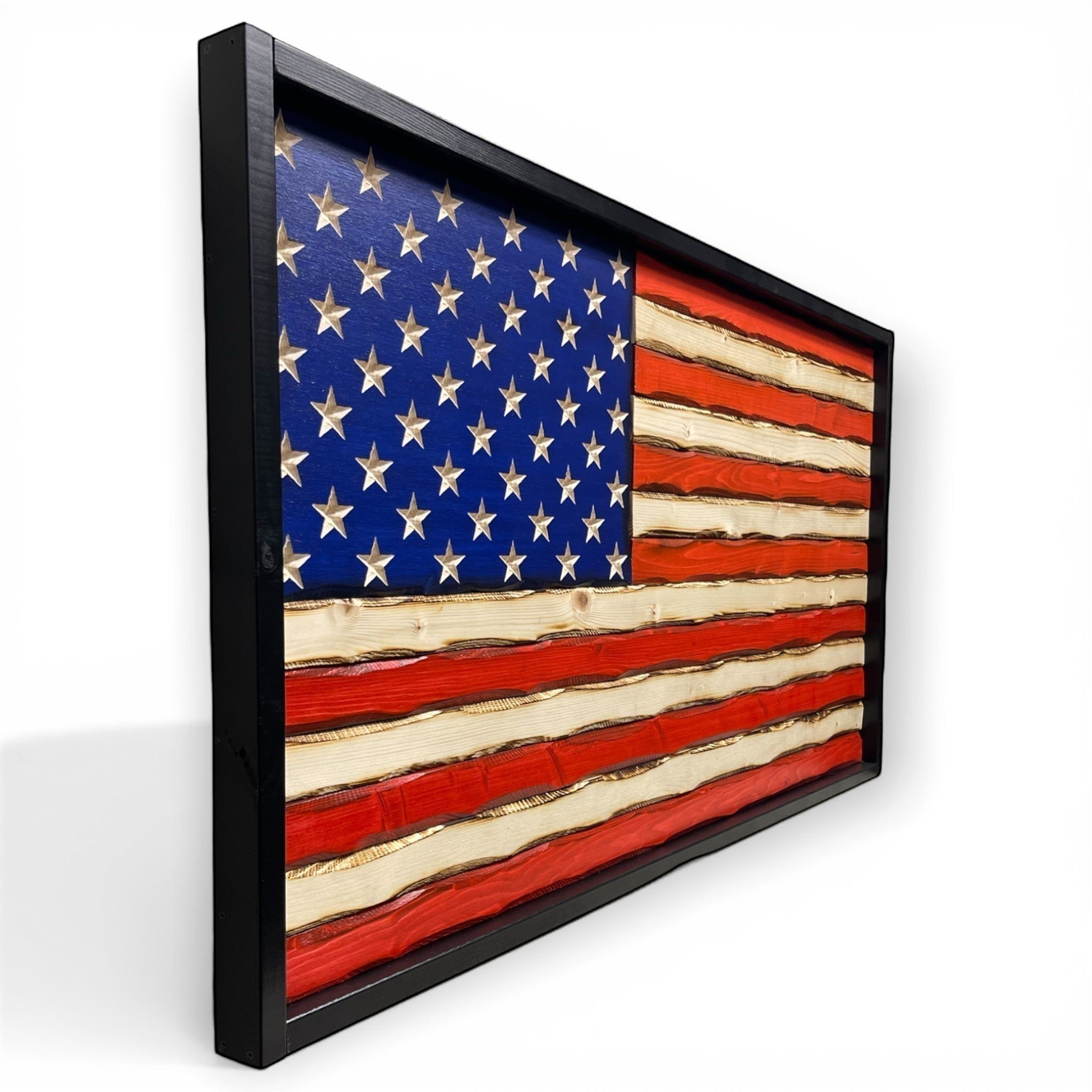 Breacher Rustics black framed wooden American flag with carved stars and battle-worn patina finish. american flag carved wood wall art handmade patriotic decor rustic wooden flag usa made craftsmanship