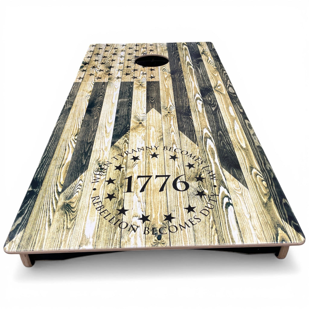 Breacher Rustics 1776 Tyranny/Rebellion USA flag cornhole set with wood grain finish. Features stars and patriotic quote.