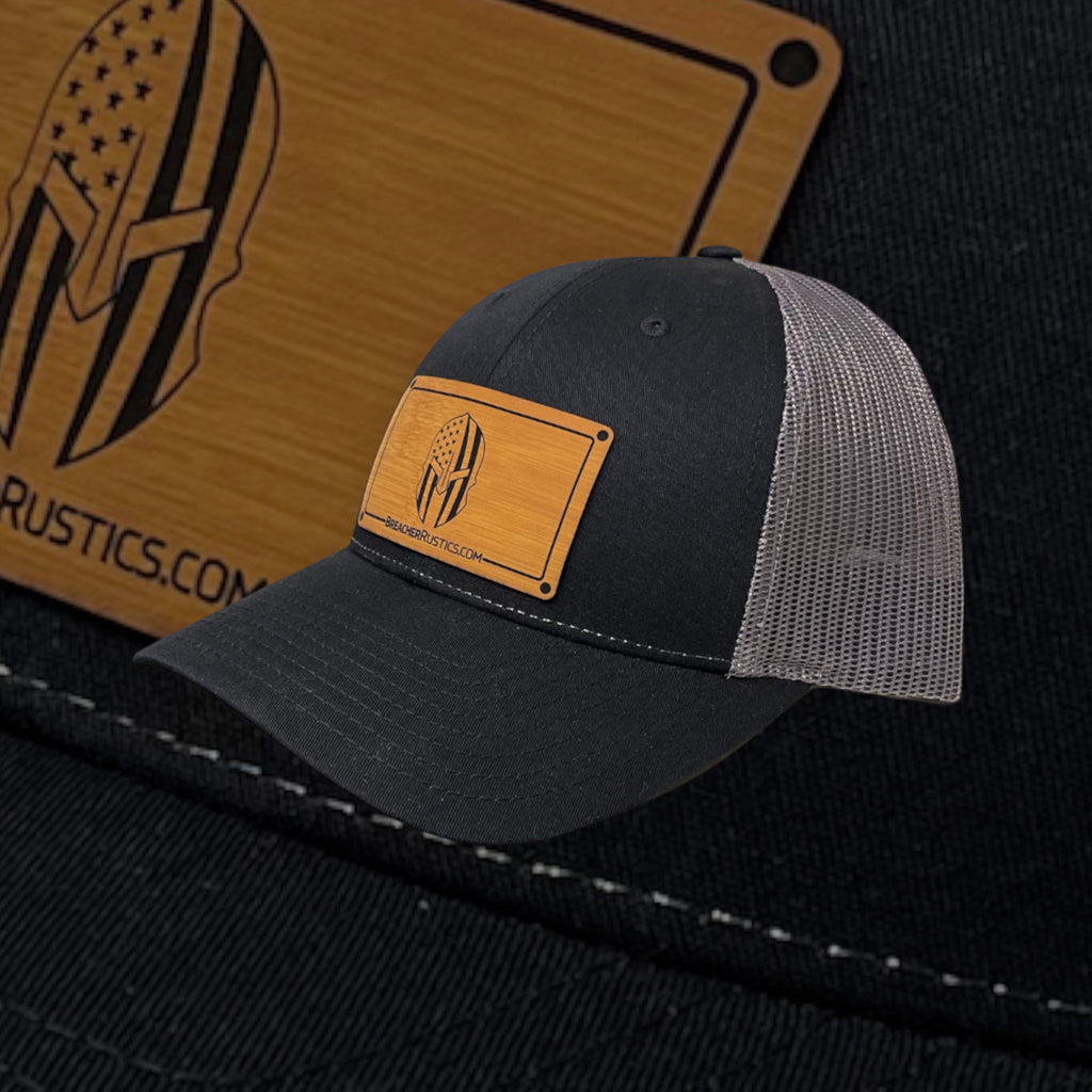 Breacher Rustics black cotton/nylon trucker hat with American flag Spartan helmet patch and grey mesh back. Adjustable snapback.