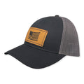 Breacher Rustics black cotton-nylon trucker hat with grey mesh back and a bamboo leather patch featuring a draped American flag.