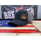 Breacher Rustics black trucker hat with grey mesh back and leather patch logo. Structured, six-panel, low-profile with snapback closure.