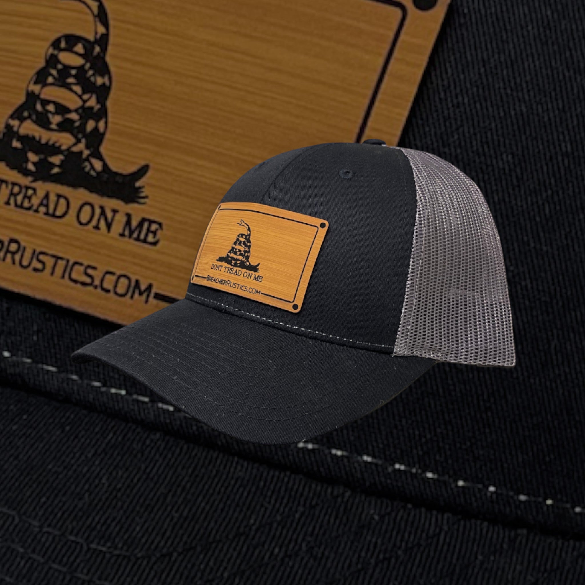 Breacher Rustics black cotton and mesh trucker hat with a bamboo leather patch featuring the Don't Tread On Me snake.