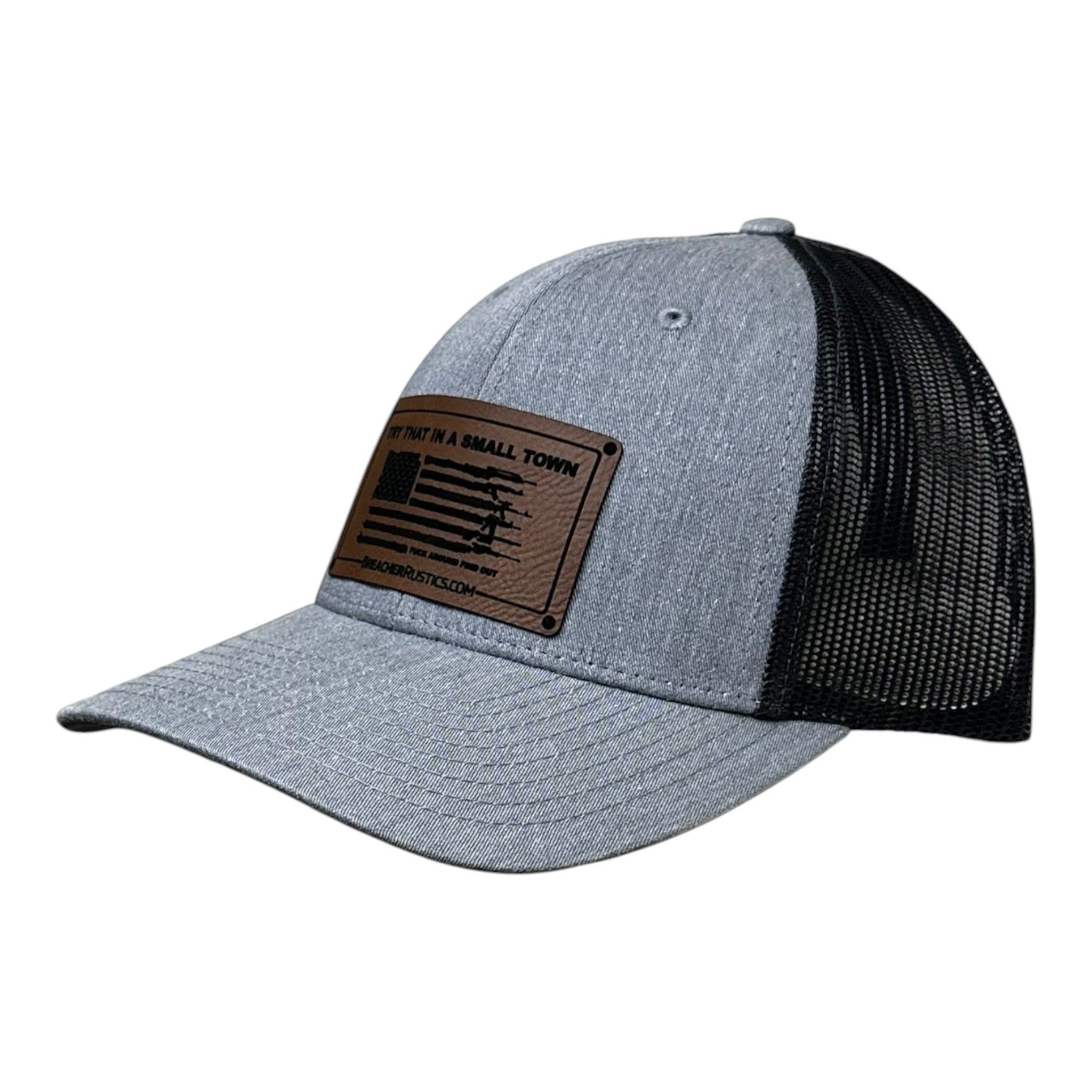 Breacher Rustics grey heather trucker hat with black mesh back and leather patch featuring an American flag with firearms. Jason Aldean