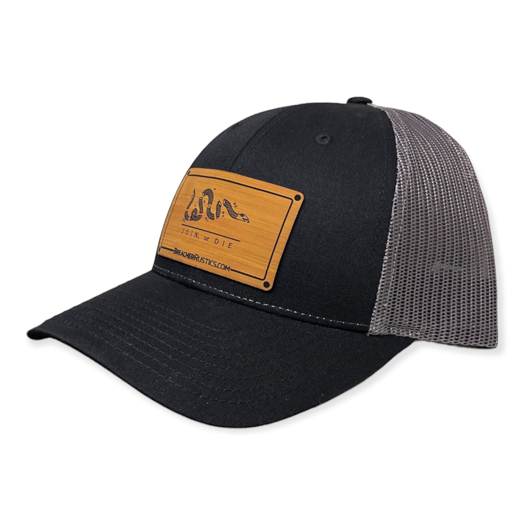 Breacher Rustics black cotton trucker hat with grey mesh back and bamboo leather patch featuring the Join, or Die snake.