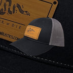 Breacher Rustics black cotton-nylon trucker hat with bamboo leather patch featuring the Join, or Die snake emblem and adjustable snapback.