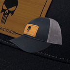 Breacher Rustics dark grey trucker hat with Punisher skull bamboo leather patch and adjustable snapback.