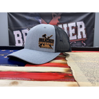 Breacher Rustics silver trucker hat with black mesh back and leather patch logo. Six-panel, low-profile, pre-curved visor, snapback closure.