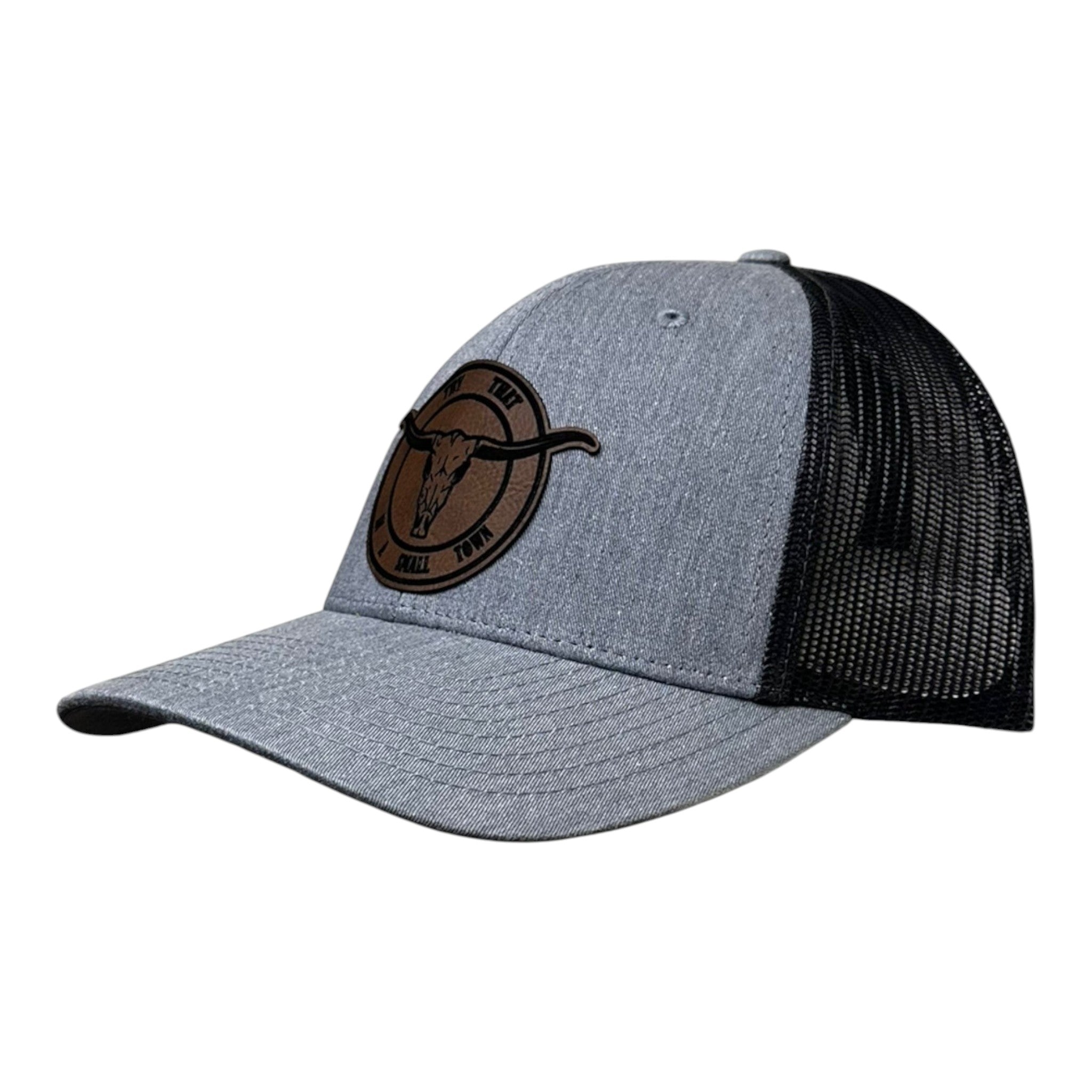 Breacher Rustics grey heather trucker hat with black mesh back and a bamboo leather patch featuring a bull skull and "Try That In A Small Town" text. Jason Aldean