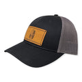 Breacher Rustics black trucker hat with grey mesh back and bamboo leather patch featuring a Spartan helmet with American flag design.