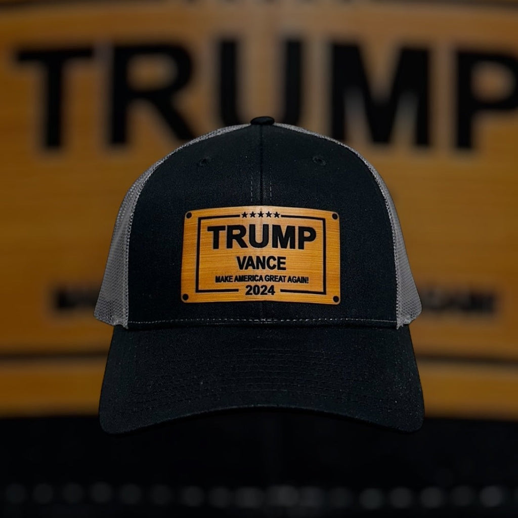 Breacher Rustics Trump Vance 2024 hat with bamboo leather patch, black front, grey mesh back, and adjustable snapback.