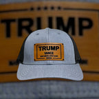 Breacher Rustics grey cotton blend trucker hat with black mesh back and bamboo leather patch featuring Trump Vance 2024 Make America Great Again.