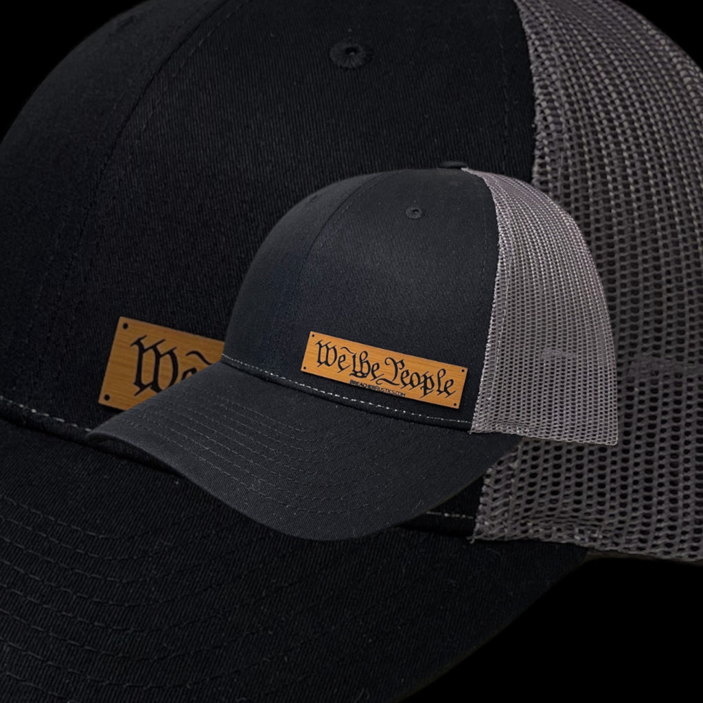Breacher Rustics black cotton-nylon trucker hat with a bamboo leather patch that says "We the People".