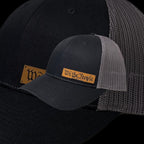 Breacher Rustics black cotton-nylon trucker hat with a bamboo leather patch that says "We the People".