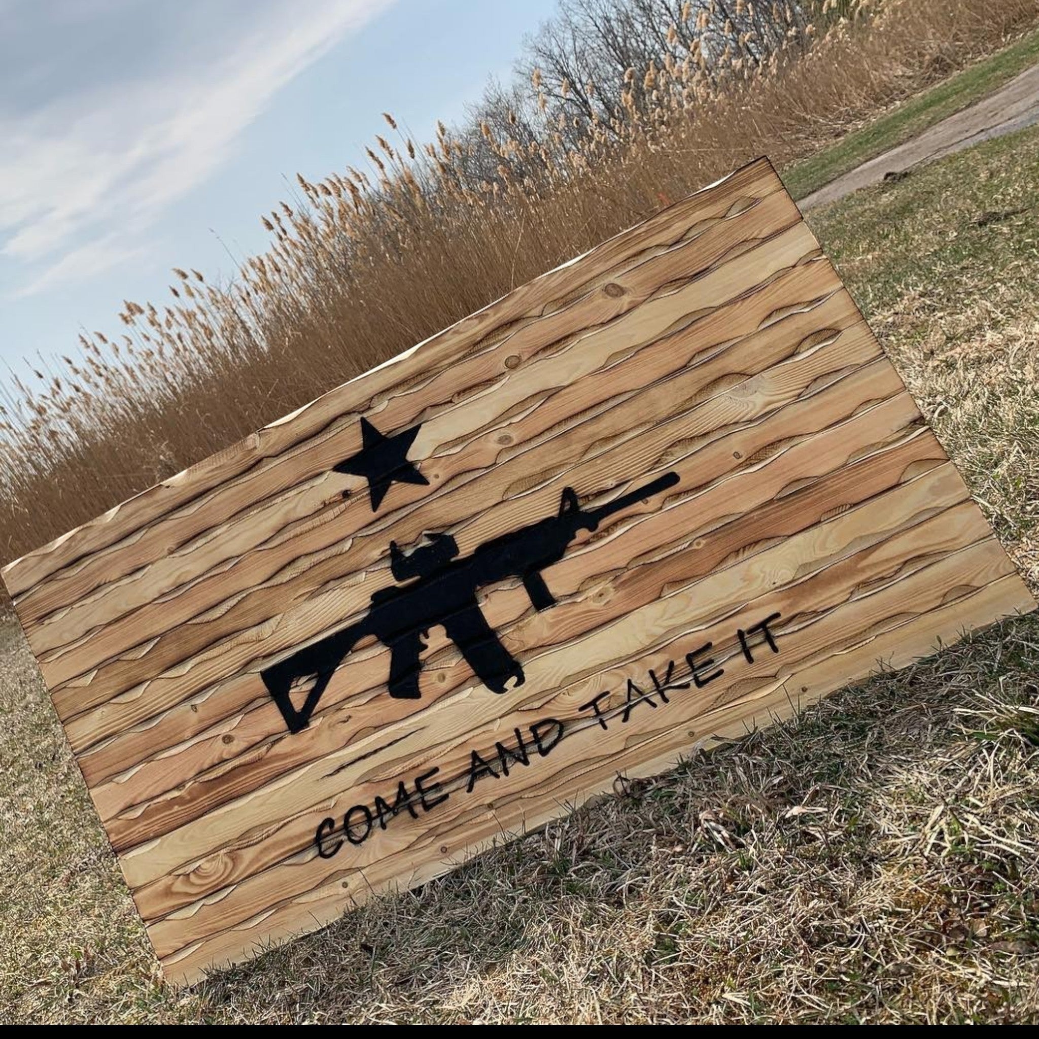Breacher Rustics wooden flag with a battle-worn look, featuring a carved rifle and the phrase "Come and Take It". come and take it patriotic wood wall flag carved battle worn american history texas revolution inspired wall decor