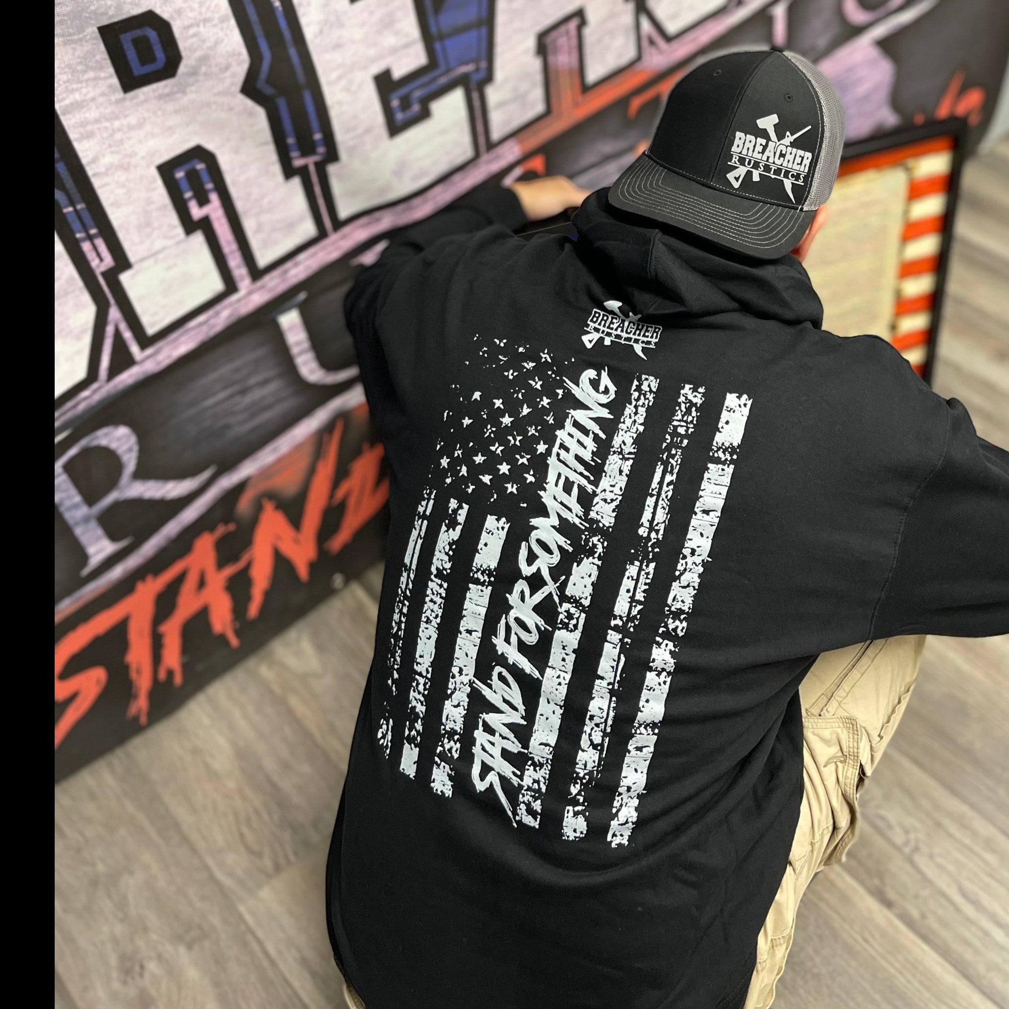 Black Breacher Rustics pullover hoodie with distressed American flag graphic and "Stand For Something" text. Cotton-poly blend. first responder patriotic hoodie breacher rustics apparel law enforcement military supporter hoodie comfortable fit