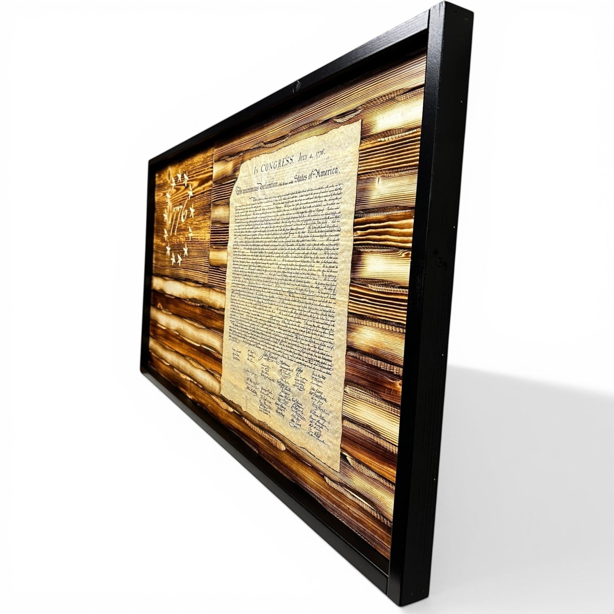 Breacher Rustics carved wood flag featuring the Declaration of Independence and "1776" in the union, with a battle-worn burned wood finish and black frame. rustic 1776 battle worn american flag wood wall decor carved patriotic home decoration usa made craftsmanship