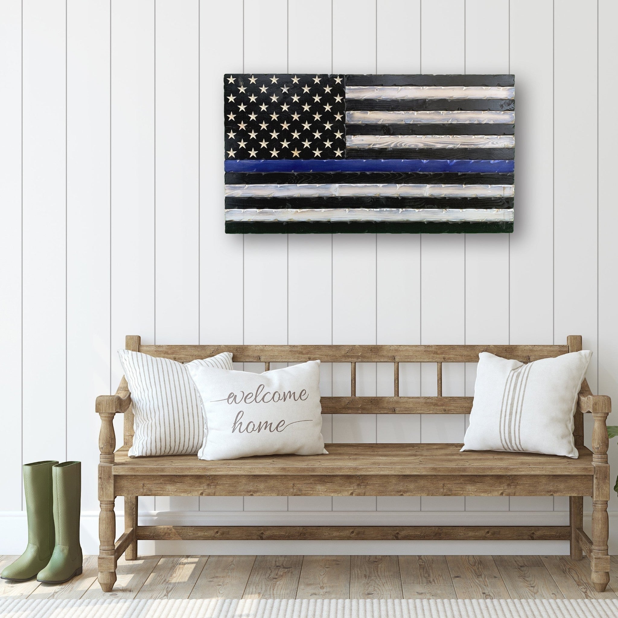Breacher Rustics Thin Blue Line wooden American flag with black stripes and a blue stripe, displayed on a white paneled wall. thin blue line american flag wood wall decor carved patriotic wooden flag police support home decoration usa made
