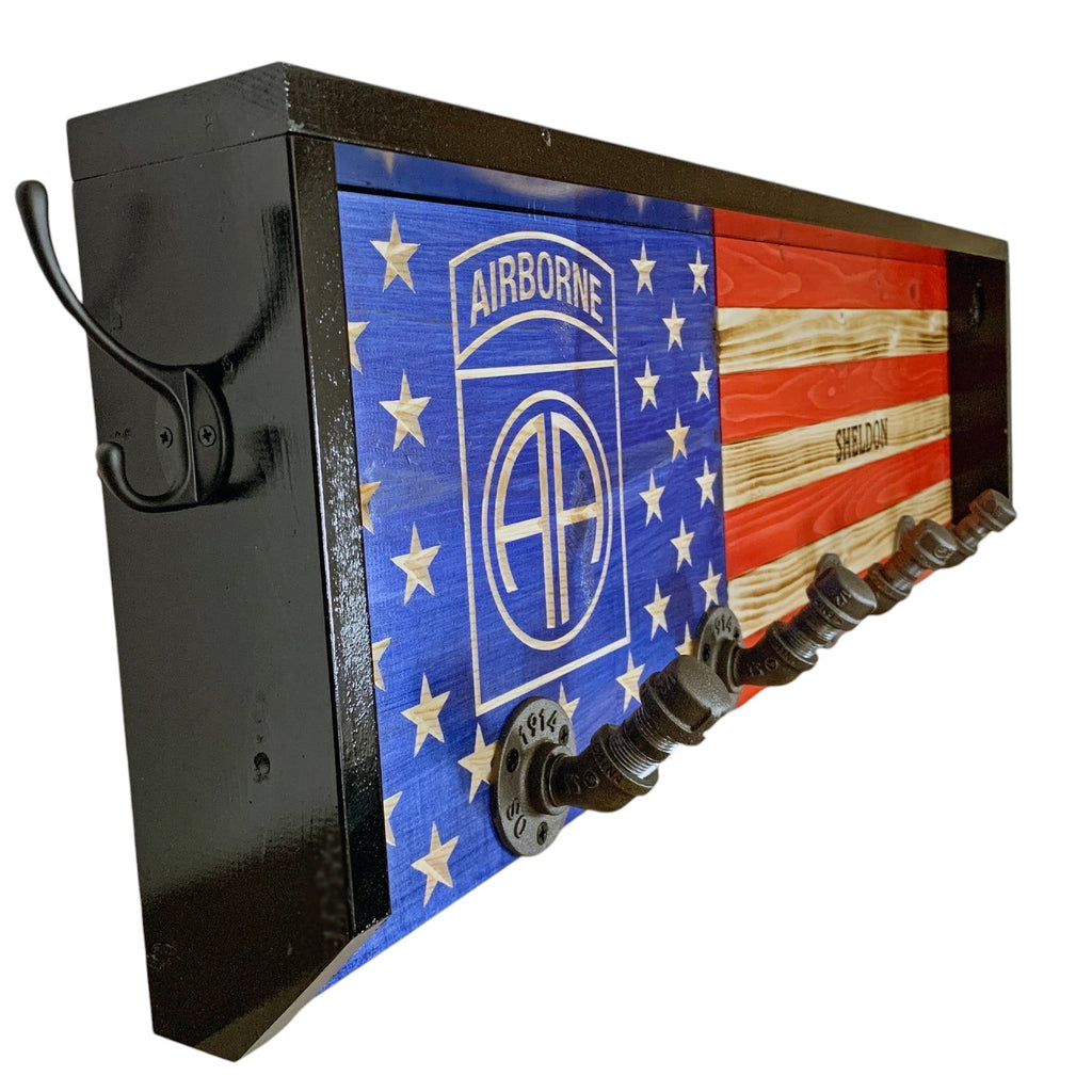 Breacher Rustics custom wooden American flag coat rack with Airborne logo and pipe hooks. Black frame, blue union, red and natural wood stripes. airborne coat rack custom logo wooden wall mounted hook rack military patriotic entryway organizer usa made